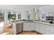 Open kitchen offers stainless steel appliances, dishwasher, and a breakfast bar, and view to living room at 3311 Fieldwood Se Dr, Smyrna, GA 30080