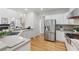 Gourmet kitchen featuring stainless steel appliances, gray countertops, hardwood floors and ample white cabinets at 3311 Fieldwood Se Dr, Smyrna, GA 30080
