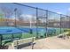 Community tennis courts surrounded by a tall fence and trees, offering a private playing environment at 3311 Fieldwood Se Dr, Smyrna, GA 30080