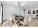 Stylish dining room featuring wainscoting, modern lighting, and an adjacent open kitchen at 4833 Glenwhite Dr, Duluth, GA 30096