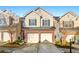 Traditional townhouse with a two-car garage and well-maintained landscaping in a suburban setting at 5538 Cascade Sw Rdg, Atlanta, GA 30336