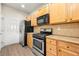 Functional kitchen with wood cabinets, appliances, and durable countertops, perfect for home cooking at 5538 Cascade Sw Rdg, Atlanta, GA 30336