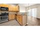 Modern kitchen with stainless appliances, wood cabinets, and dining area access at 5538 Cascade Sw Rdg, Atlanta, GA 30336