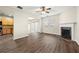 Open-concept living space with laminate flooring, kitchen access, fireplace, and windows at 5538 Cascade Sw Rdg, Atlanta, GA 30336