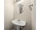 Clean powder room featuring a pedestal sink, round mirror, and neutral decor at 5538 Cascade Sw Rdg, Atlanta, GA 30336