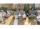 Aerial view of a traditionally styled home with a long driveway, situated amongst mature trees and neighboring houses at 675 Timber Ives Dr, Dacula, GA 30019