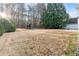 Expansive backyard with mature trees, a play structure, and plenty of space for recreation at 675 Timber Ives Dr, Dacula, GA 30019