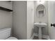 Powder bathroom with a pedestal sink, modern fixtures and tile flooring at 675 Timber Ives Dr, Dacula, GA 30019