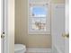 Bathroom features a window over the toilet and a white tiled shower and tub at 675 Timber Ives Dr, Dacula, GA 30019