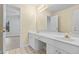 Well lit ensuite bathroom featuring double sinks, ample counter space and neutral paint at 675 Timber Ives Dr, Dacula, GA 30019