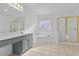 Bathroom with a soaking tub and a shower with gold trim at 675 Timber Ives Dr, Dacula, GA 30019