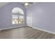 Spacious bedroom with arched window, lots of natural light, and hardwood floors at 675 Timber Ives Dr, Dacula, GA 30019