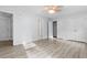 Large bedroom with modern ceiling fan, laminate floor, and multiple closets and doors at 675 Timber Ives Dr, Dacula, GA 30019