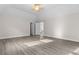 Open bedroom with vaulted ceiling and doorway leading to staircase at 675 Timber Ives Dr, Dacula, GA 30019