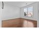 Bright bedroom features hardwood floors, ample natural light from the window, and neutral decor at 675 Timber Ives Dr, Dacula, GA 30019