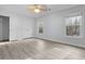 Bedroom featuring bright gray walls, wood-look floors, two windows, and double-door closet at 675 Timber Ives Dr, Dacula, GA 30019