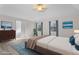 Staged main bedroom features a bed, tv, artwork, laminate floors, and ensuite bathroom at 675 Timber Ives Dr, Dacula, GA 30019