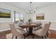 Elegant dining room with a large window, modern light fixture, and stylish decor at 675 Timber Ives Dr, Dacula, GA 30019