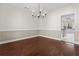 This dining room features hardwood floors, two-tone paint and a view into the neighboring room at 675 Timber Ives Dr, Dacula, GA 30019