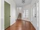 Welcoming foyer with hardwood floors, staircase, and glass paneled doors, offering a grand entrance at 675 Timber Ives Dr, Dacula, GA 30019