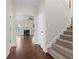Inviting foyer with hardwood floors, staircase, and view into the living room at 675 Timber Ives Dr, Dacula, GA 30019