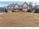 Charming brick home with a two-car garage and front porch, on a large lot with mature trees at 675 Timber Ives Dr, Dacula, GA 30019