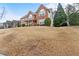 Charming two-story brick home with an attached garage and landscaped front yard, set on a large lawn at 675 Timber Ives Dr, Dacula, GA 30019
