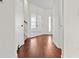 Bright hallway with hardwood floors and white french doors, offering a view into the adjacent rooms at 675 Timber Ives Dr, Dacula, GA 30019