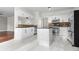Spacious kitchen featuring an island, stainless appliances, tile backsplash and bright, marble-look flooring at 675 Timber Ives Dr, Dacula, GA 30019