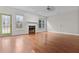 Sunlit living room boasts wood floors, fireplace, and multiple windows offering beautiful views at 675 Timber Ives Dr, Dacula, GA 30019