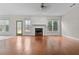Open-concept living room with hardwood floors, fireplace, and large windows offering abundant natural light at 675 Timber Ives Dr, Dacula, GA 30019