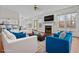 Staged living room boasts a fireplace, large windows, and stylish seating arrangement perfect for entertaining at 675 Timber Ives Dr, Dacula, GA 30019