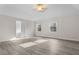 Main bedroom with laminate flooring and a doorway to an en-suite bathroom at 675 Timber Ives Dr, Dacula, GA 30019