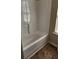 Bathroom with a white tub and shower, and tile flooring at 1986 Villa Spring Ct, Dacula, GA 30019