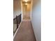 Upstairs hallway featuring neutral walls, carpeted floor, and a dark wood railing at 1986 Villa Spring Ct, Dacula, GA 30019