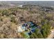 Aerial view featuring community amenities: sparkling pool, tennis courts, and a clubhouse surrounded by lush trees at 2115 Azalea Dr, Roswell, GA 30075