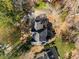 An aerial view of the home's roof, backyard, driveway and surrounding treed landscape at 2115 Azalea Dr, Roswell, GA 30075