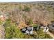 An aerial view of the home, surrounded by a lush forest, showcasing its private setting at 2115 Azalea Dr, Roswell, GA 30075