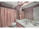 Pink bathroom featuring pink wallpaper, a pink shower curtain, and a white countertop at 2115 Azalea Dr, Roswell, GA 30075