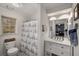 Stylishly appointed bathroom featuring a vanity with marble countertops and a nautical themed shower curtain at 2115 Azalea Dr, Roswell, GA 30075