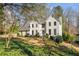 Charming white brick home with a well-manicured front yard and mature trees, offering great curb appeal at 2115 Azalea Dr, Roswell, GA 30075