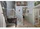 Grand foyer with blue wallpaper, wooden floors, staircase, and upper-level balcony showcasing the home's character at 2115 Azalea Dr, Roswell, GA 30075