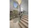 Elegant foyer with a two-story ceiling, light gray staircase, unique rug, and natural light from large windows at 2115 Azalea Dr, Roswell, GA 30075