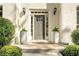 Inviting front entrance featuring a gray door, classic lanterns, and elegant planters enhancing the home's exterior at 2115 Azalea Dr, Roswell, GA 30075