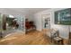 Open-concept living room with hardwood floors, french doors, and views into other rooms in this stylish home at 2115 Azalea Dr, Roswell, GA 30075