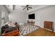 Cozy living room featuring plush seating, stylish rug, mounted tv and natural light at 2115 Azalea Dr, Roswell, GA 30075