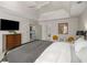 Relaxing main bedroom featuring a tray ceiling, large dresser, television, and ensuite bathroom access at 2115 Azalea Dr, Roswell, GA 30075