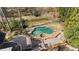 Aerial view of a private backyard oasis with a swimming pool and spa surrounded by lush landscaping at 9185 Old Southwick Pass, Johns Creek, GA 30022