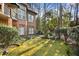 Lush backyard with mature trees and manicured lawn, adjacent to the home at 9185 Old Southwick Pass, Johns Creek, GA 30022