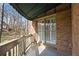 The balcony features a brick exterior, wooden railing, green awning and view of the surrounding landscape at 9185 Old Southwick Pass, Johns Creek, GA 30022